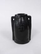 An unusual Doulton slip cast vase with black glaze and Swastika emblem,13 cm high