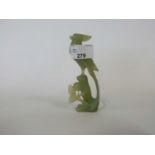 Jade model of a bird on a rock with carved flowers beneath, 12cm high