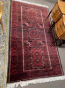 Modern Belouchi rug decorated with geometric panels on a red background, 231 x 133cm