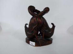Oriental pair of carved wooden ducks on shaped base, 25cm high