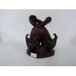 Oriental pair of carved wooden ducks on shaped base, 25cm high
