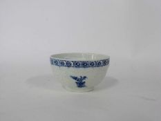 Early Lowestoft teabowl, circa 1765 with moulded floral decoration and blue floral spriggs (chip/
