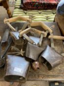 Group of five various vintage iron sheep bells with wood and leather mounts together with a pair