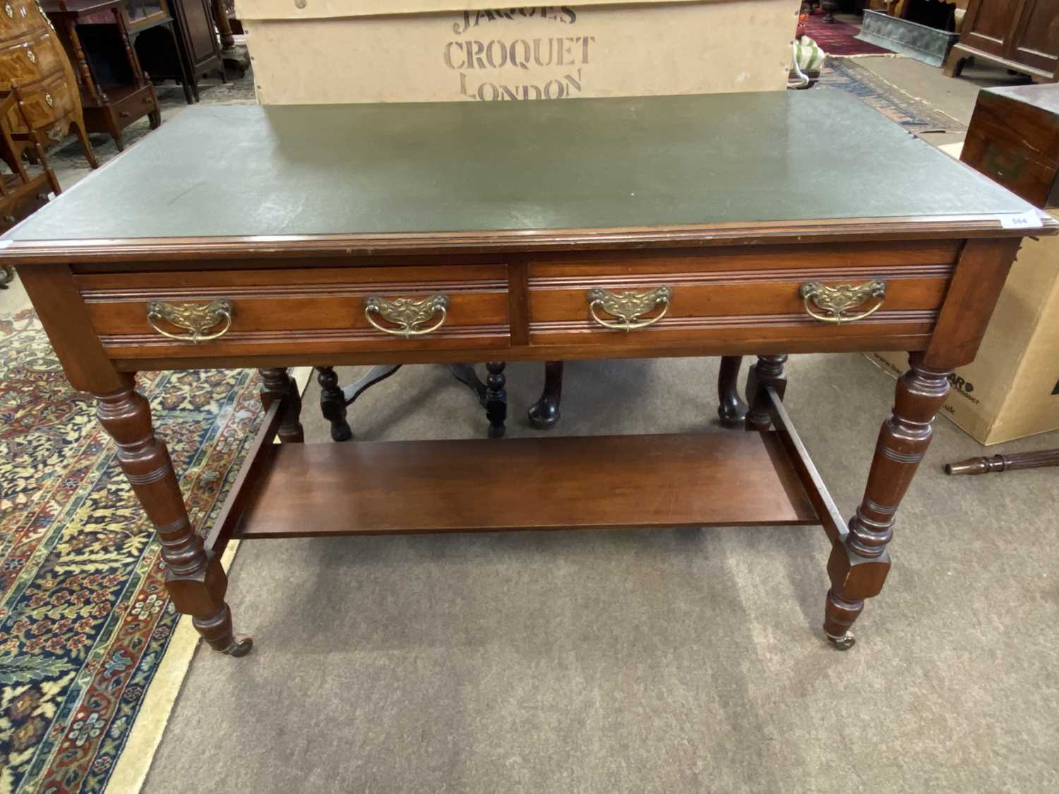 Late Victorian mahogany writing table with inset writing surface over two short drawers, turned legs
