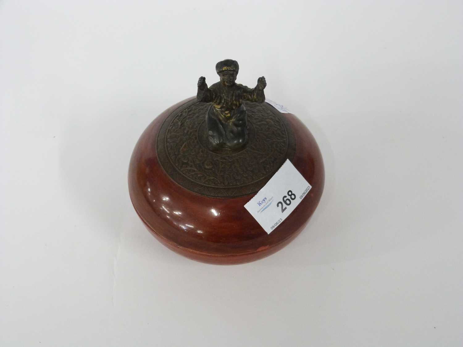 Continental porcelain circular box and cover with Oriental figure as a finial