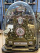 19th Century French gilt metal and porcelain mounted mantel clock of elaborate form set under a