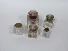 Small box containing a quantity of five early 20th Century glass ink wells