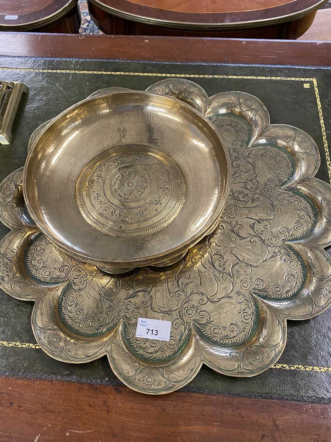 Group of three pieces of Indian brass ware comprising two lobed serving trays and a shallow circular