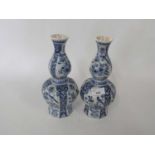 A pair of Dutch Delft vases of faceted form decorated with flowers and birds, 26cm high