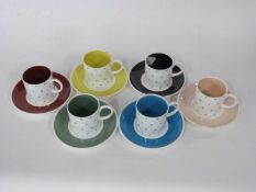 Set of six Wedgwood coffee cans and saucers with various star designs by Susie Cooper