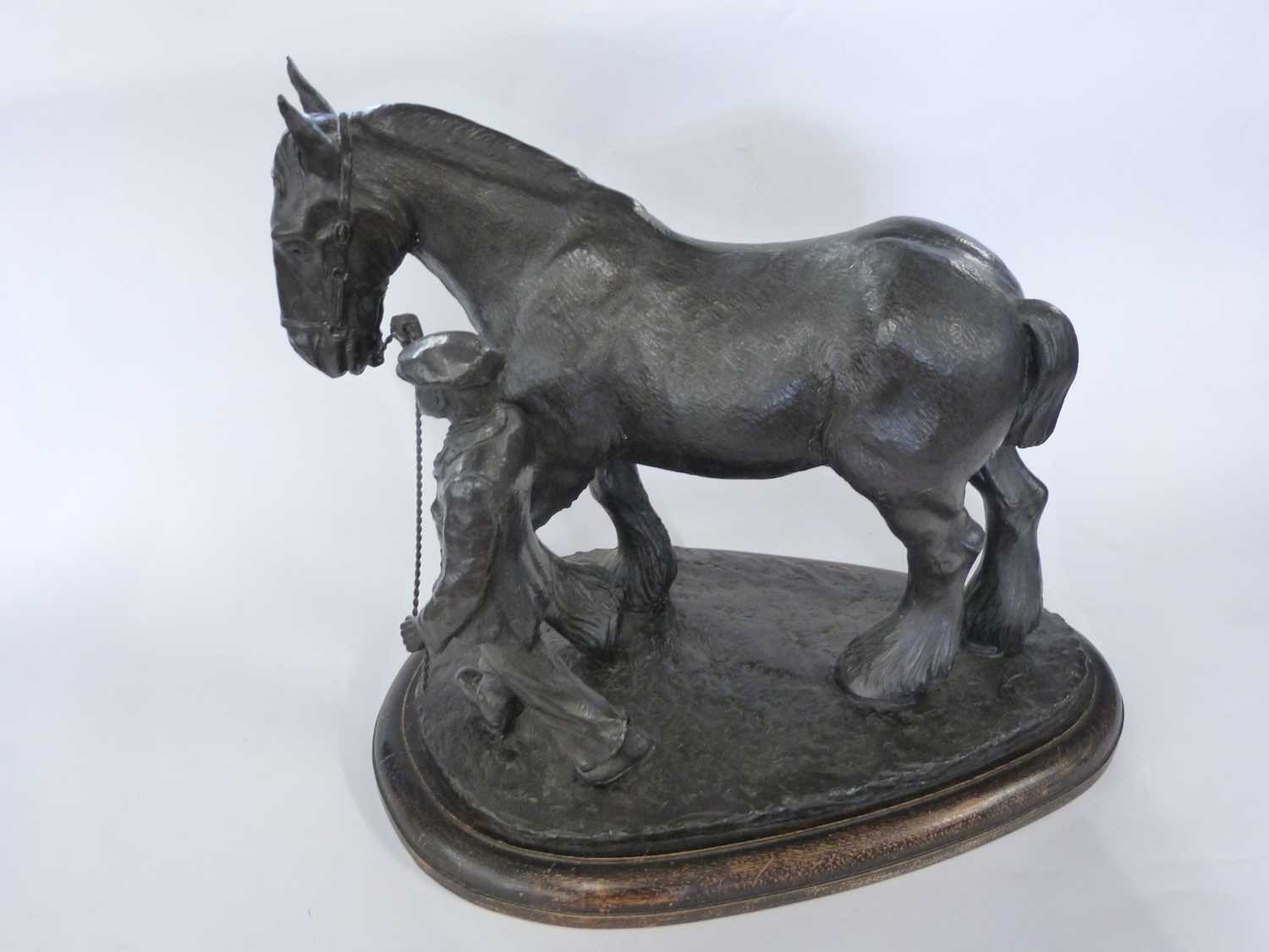 Large carved wooden model of a shire horse with farm hand on large oval wooden base, 40cm high