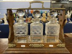 Oak and silver plate mounted three bottle tantalus, 40cm wide