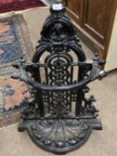 Victorian cast iron umbrella and stick stand of bow front form set with a removeable drip tray, 85cm