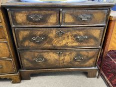 A 18th Century and later chest with two short and two long drawers, finished with walnut and cross