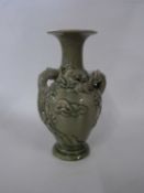 Chinese vase with celadon glaze, decorated in relief with two dragons chasing the flaming pearl,