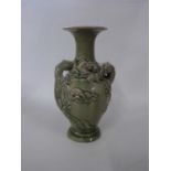 Chinese vase with celadon glaze, decorated in relief with two dragons chasing the flaming pearl,