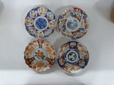 Group of four Japanese dishes with shaped rims, three with typical Imari designs and a further