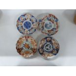 Group of four Japanese dishes with shaped rims, three with typical Imari designs and a further