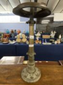 An unusual brass column formed oil lamp, 54cm high
