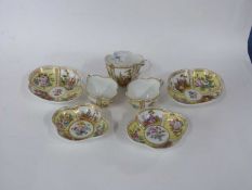Group of Dresden cups and saucers of quatrefoil shape decorated in Meissen style with panels of