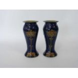 Pair of Royal Doulton Art Nouveau vases, the blue ground with Art Nouveau style flower heads, 19cm