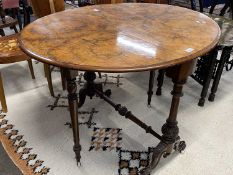 Victorian walnut veneered oval drop leaf side table raised on turned column with outswept legs and