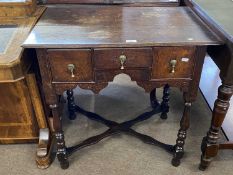 18th Century oak low boy fitted with three drawers, raised on turned legs with an X formed