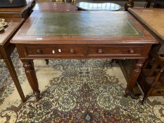 Victorian mahogany two drawer writing table with green leather inset top raised on tapering