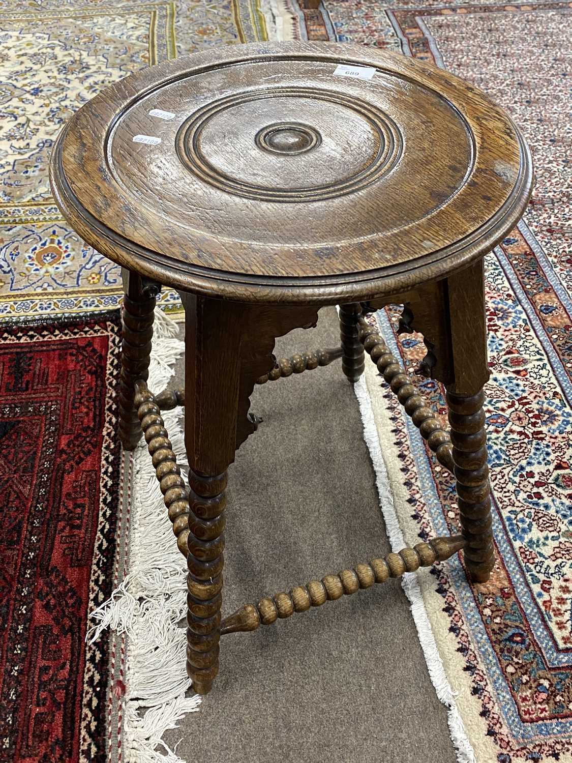 Small late 19th or early 20th Century oak occasional table raised on a bobbin turned frame bearing