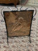 Arts & Crafts style copper and iron mounted fire screen decorated with a cormorant, 71cm high