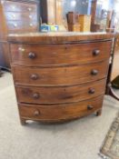 An unusual Victorian oak corner chest with four bow fronted doors with turned knob handles, 109cm