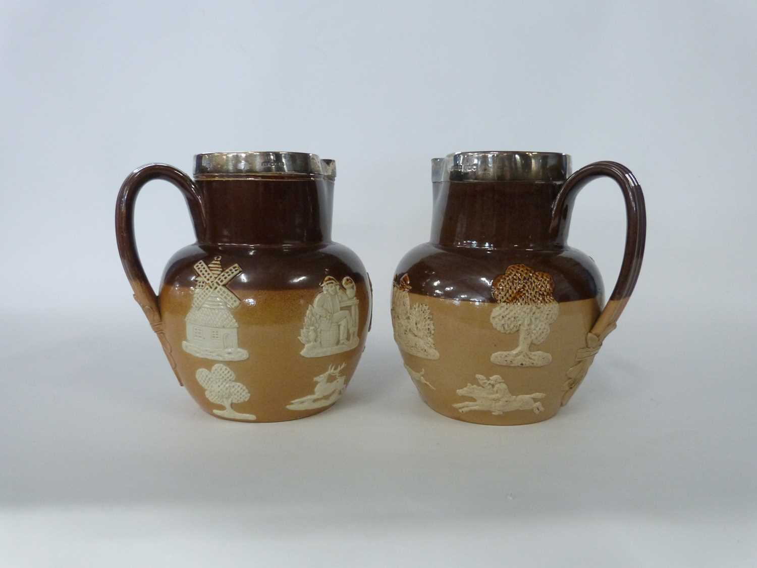 Two Doulton Lambeth harvest jugs with Sheffield silver rims