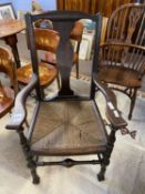 A 19th Century rush seated carver chair on turned frame