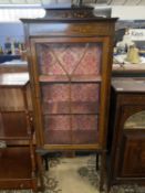 Edwardian mahogany and inlaid china display cabinet with single door opening to a fabric lined