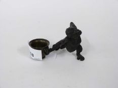 Bronze model of a monkey holding a bowlitem is 6cm high and 9cm long