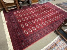 Super Keshan floor rug decorated with a geometric design on a red background