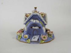 19th Century English porcelain pastille type burner modelled as a house with applied floral