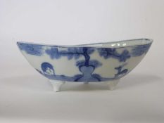 Oriental porcelain sauceboat, 19th Century, raised on three stub feet, decorated with figures and