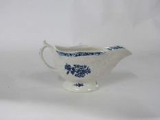 Lowestoft porcelain sauce boat circa 1780 with a blue printed design, the body with moulded floral