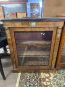 Victorian walnut veneered single doored display cabinet with applied metal mounts and central