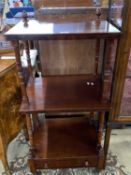 Victorian mahogany what-not of typical form with turned column supports and base drawer, raised on