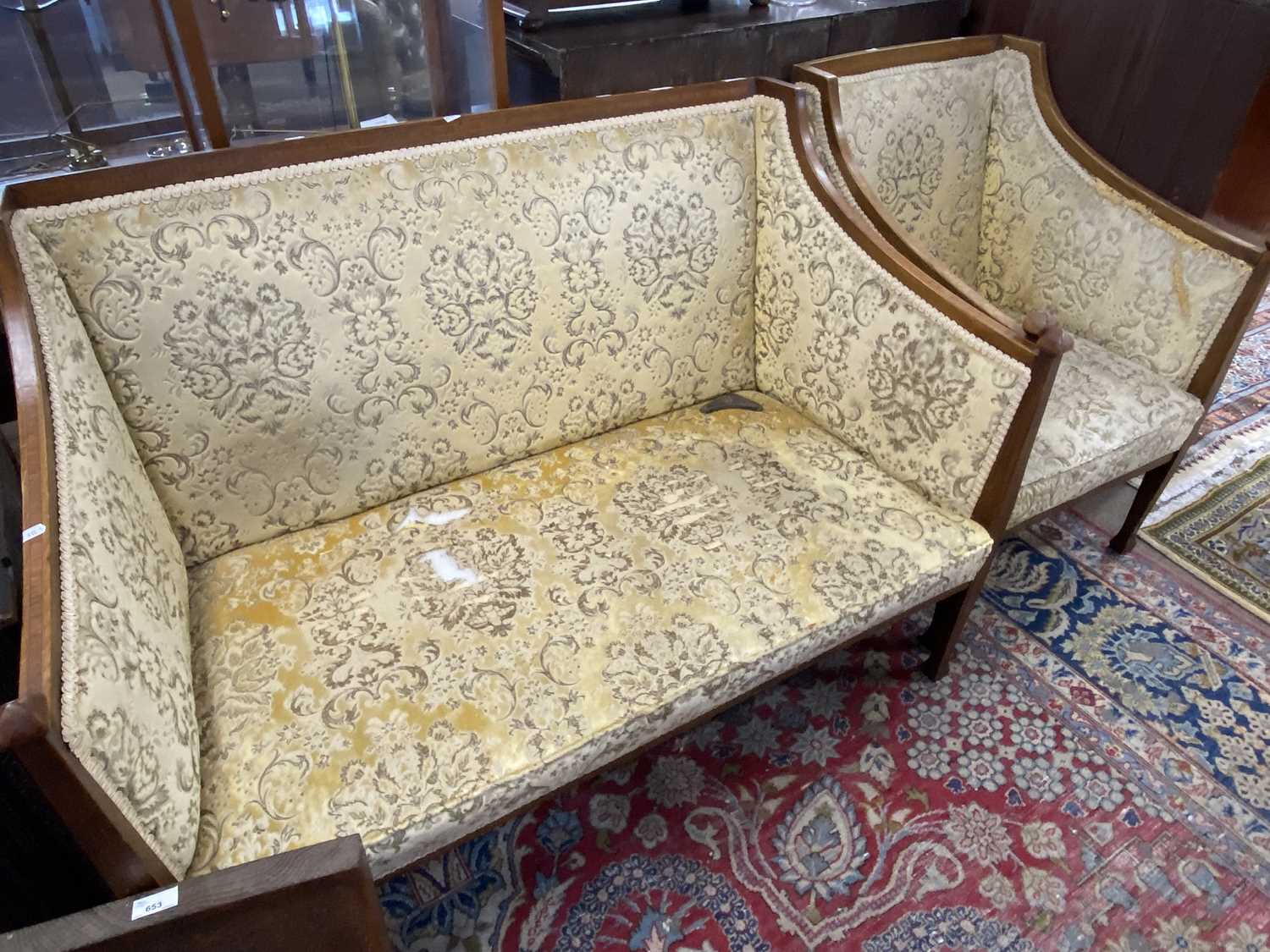 Edwardian mahogany framed and floral upholstered two seater sofa together with a matching