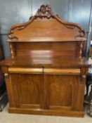 Victorian mahogany chiffonier with arched back decorated with applied carved detail over a base with