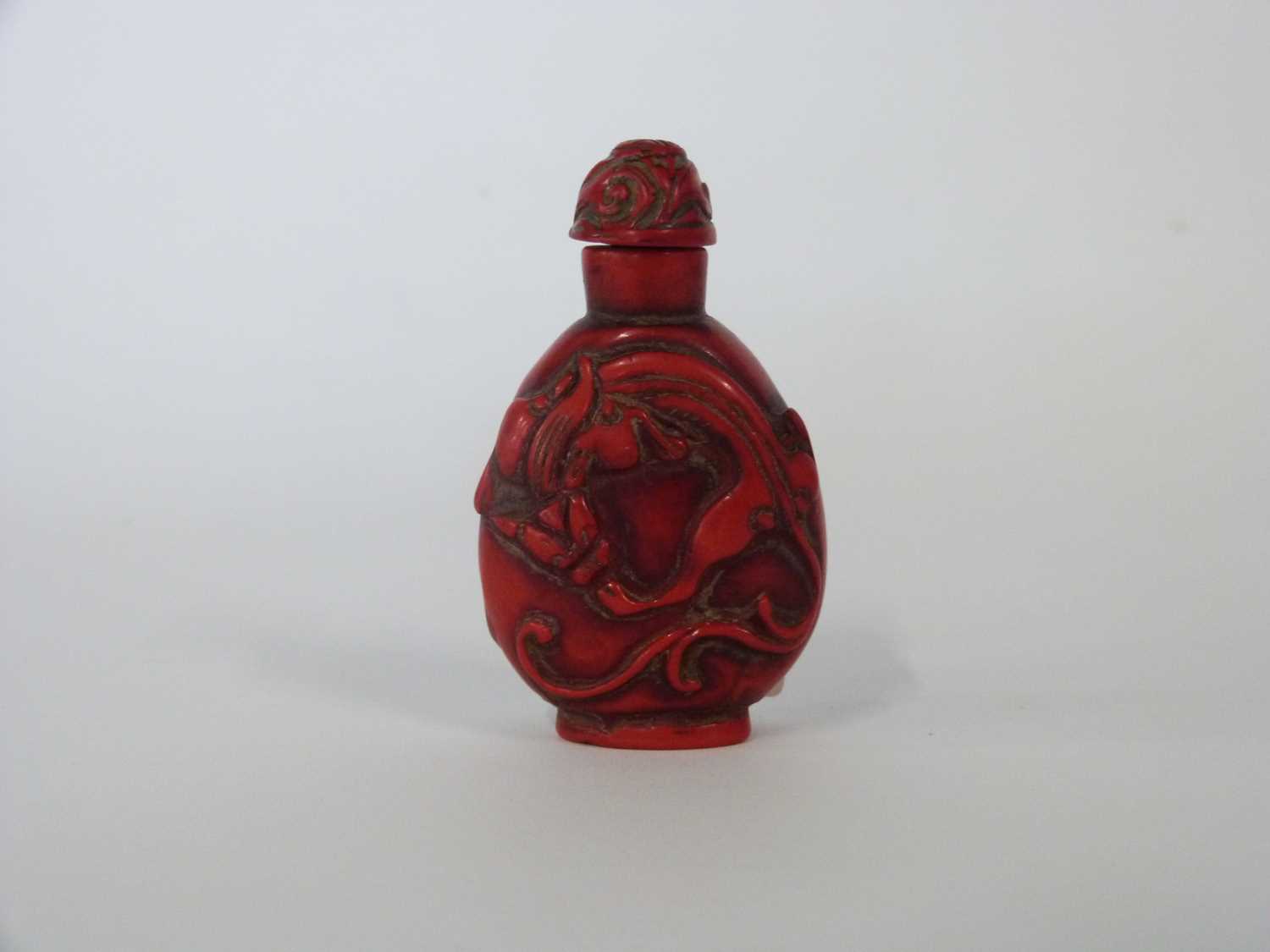 Chinese scent bottle, red coloured carved with a dragon