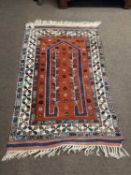 Modern Middle Eastern wool floor rug decorated with a large central red panel surrounded by a