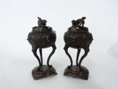 Pair of Chinese bronze censers with pierced covers and with Kylin type finials, the censers raised