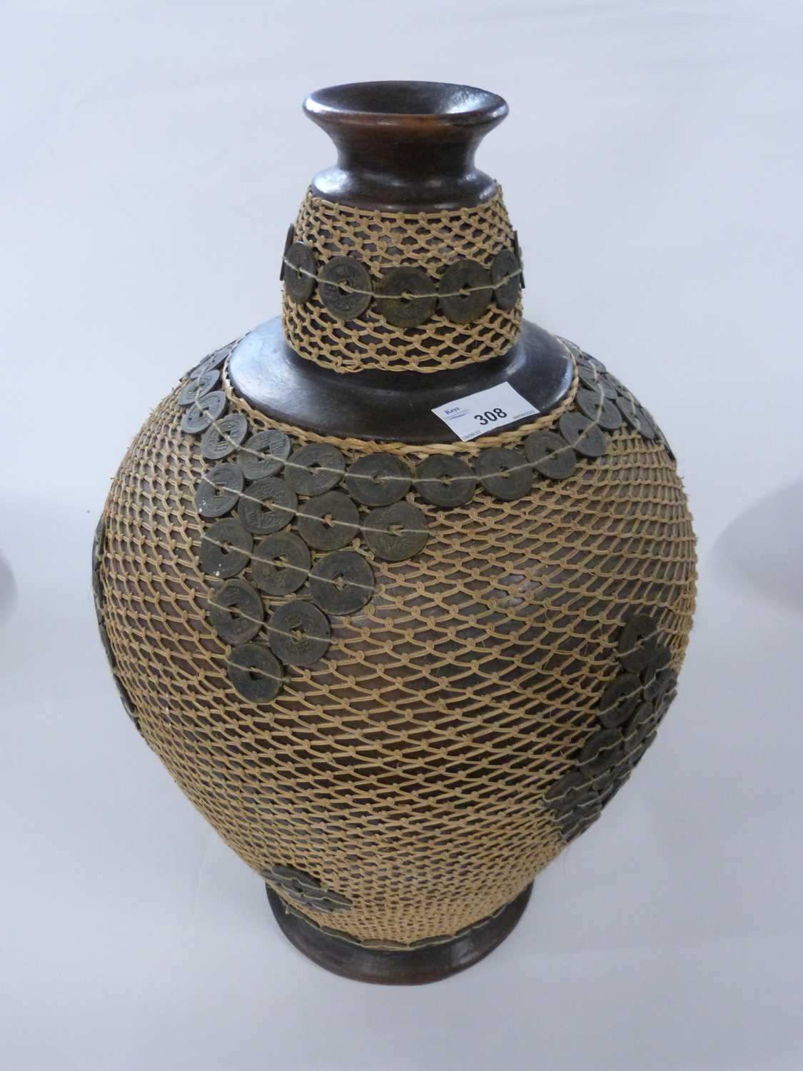 Large pottery vase of baluster form decorated with Chinese coins, 50cm high