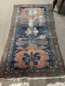 Antique Middle Eastern wool floor carpet decorated with large central red and blue panel, 184 x