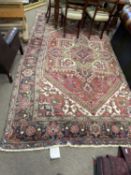 Large 20th Century Middle Eastern wool floor rug decorated with a central panel of geometric