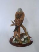 A Border Fine Arts figure of a red kite entitled Red Alert on circular wooden base, 35cm high